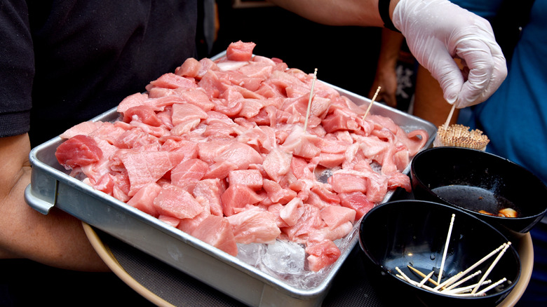 Tray of person prepping samples of tuna