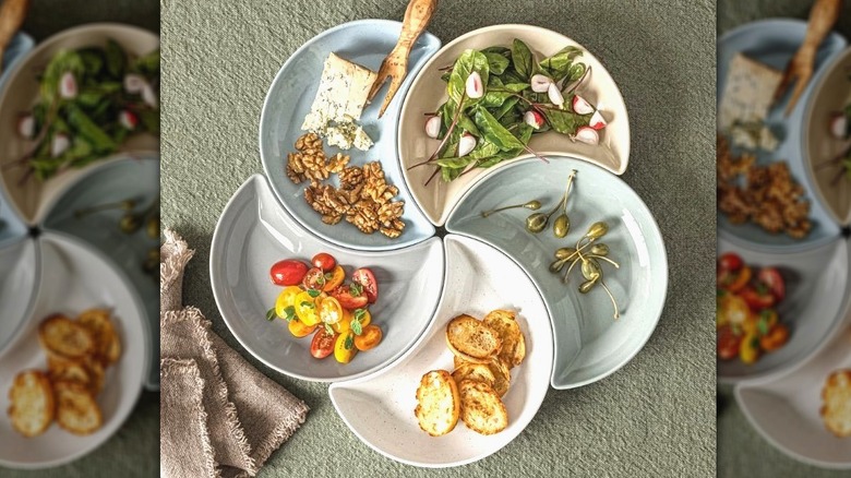 Five crescent-shaped dishes in a modular round Serving Set