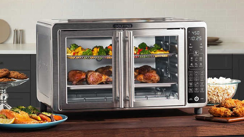 Gourmia XL Digital Air Fryer Toaster Oven filled with vegetables and meat on a kitchen counter