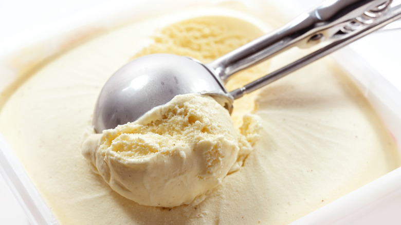 scooping vanilla ice cream