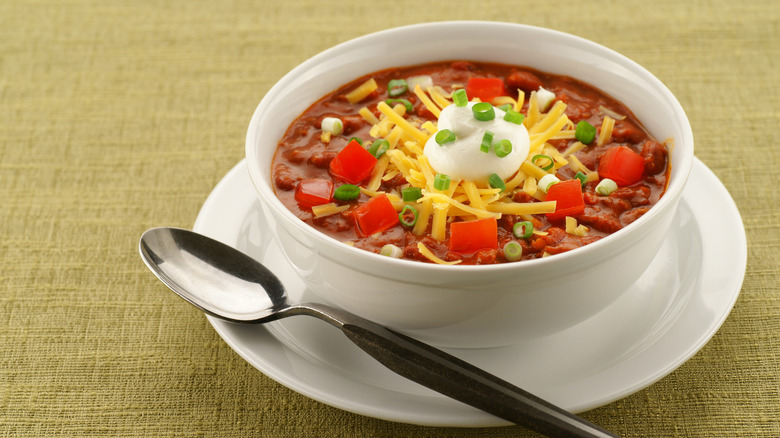 white bowl of chili with spoon