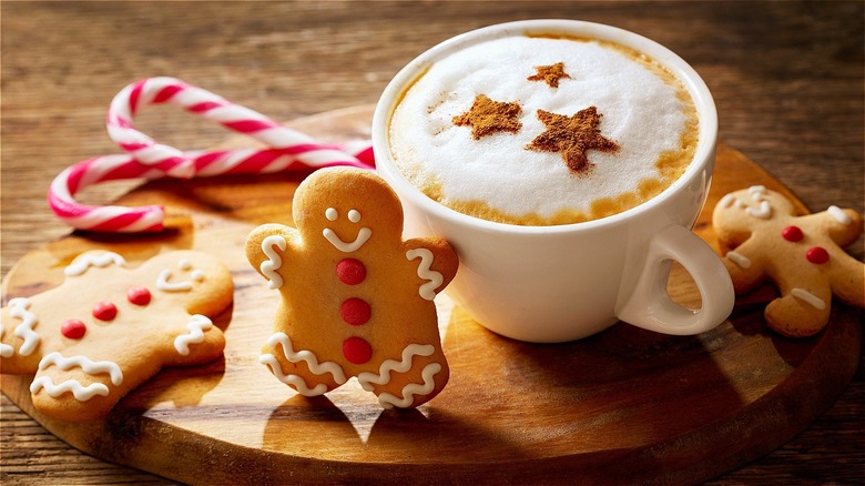 Gingerbead man next to latte in a mug