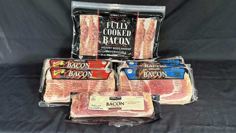 Multiple Kirkland bacon packages on black background