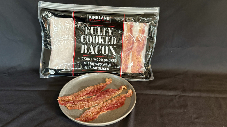 Kirkland fully cooked bacon package behind plate of cooked bacon