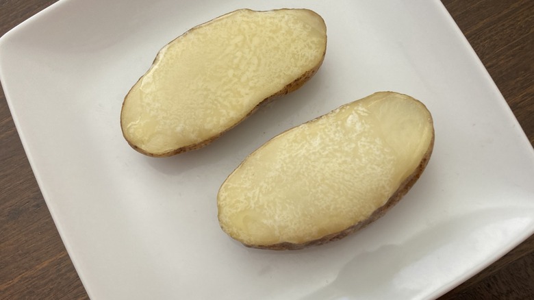 melted butter on baked potato halves