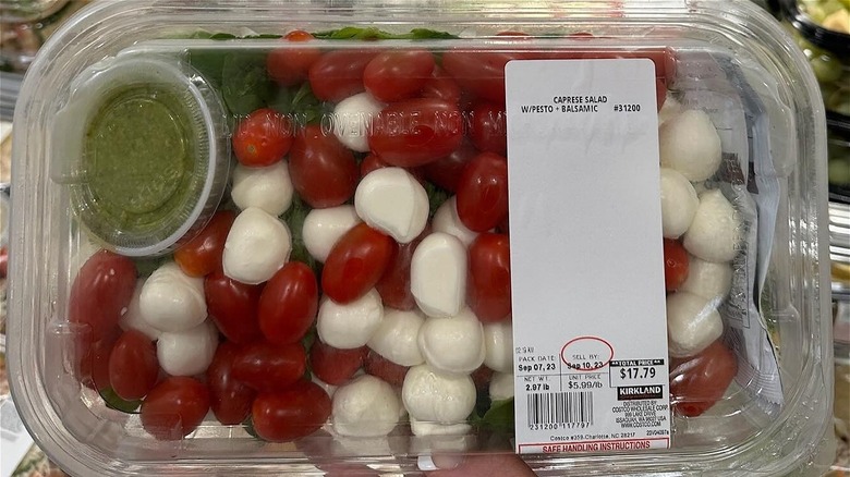 hand holding Costco caprese salad