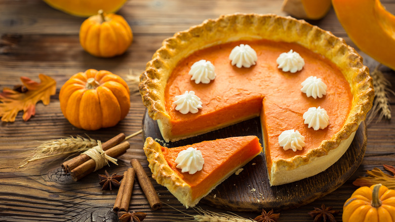 A pumpkin pie on a wooden table