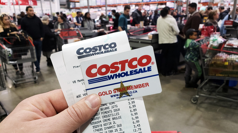 Person holding Costco membership card