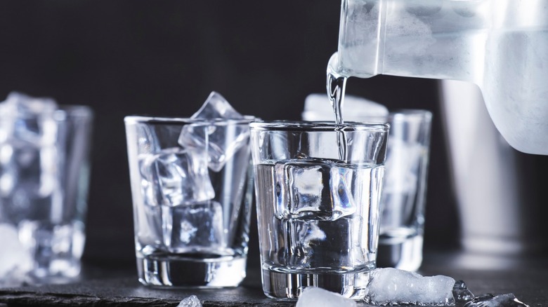 Vodka being poured into glasses