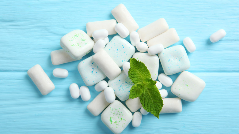 Various pieces of gum around a mint leaf