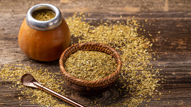 Small basket and traditional container of dry yerba mate tea with spoon