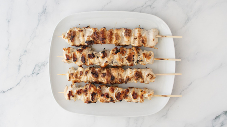 Grilled chicken skewers on plate