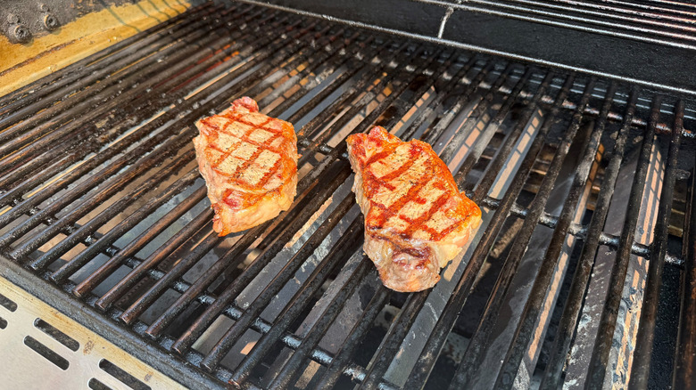 Grilled steaks on grill