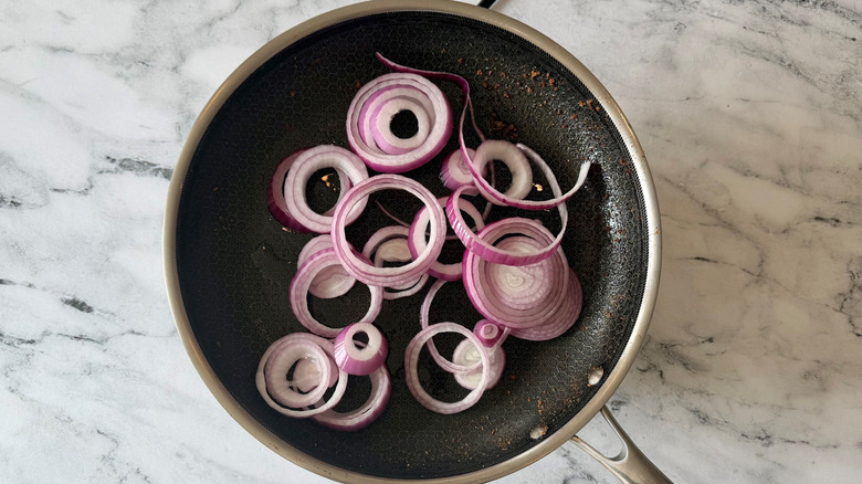 Red onion rings in pan