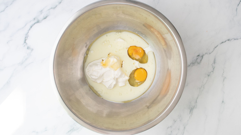 Eggs, milk, and sour cream in bowl