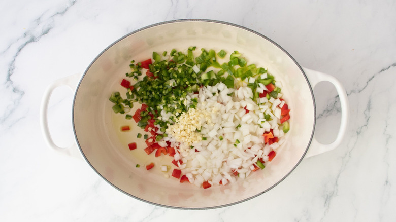 Diced onion and peppers in Dutch oven