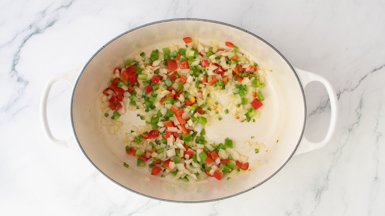 Diced onion and peppers in Dutch oven