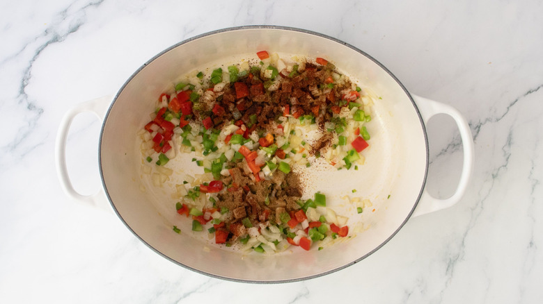Diced veggies with seasonings in Dutch oven