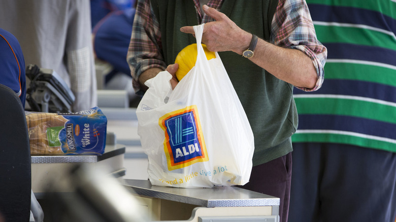 Person bagging groceries at Aldi