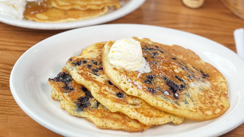 Two plates of Cracker Barrel fruit pancakes.