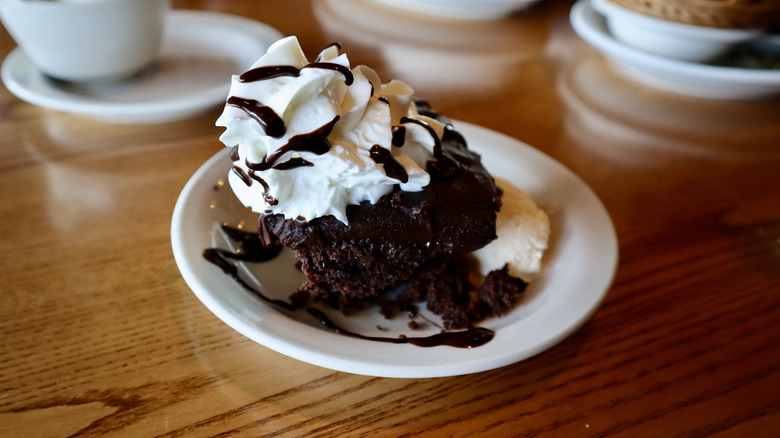 chocolate cake with whipped cream on plate