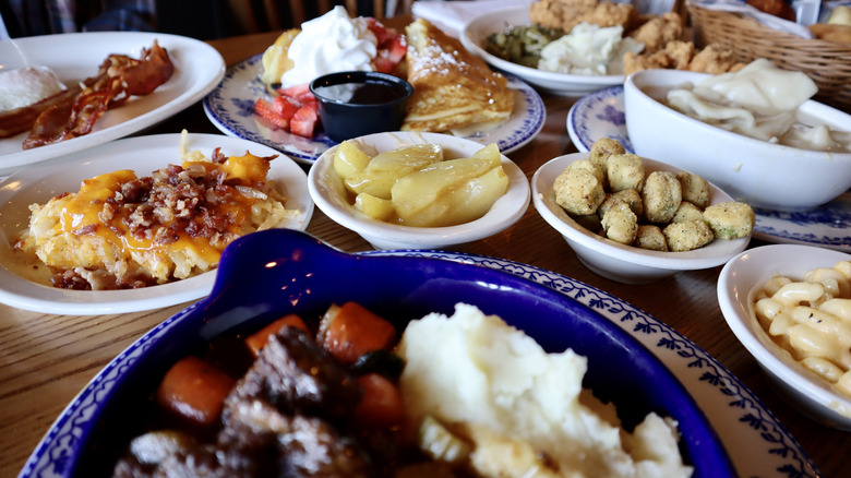 table covered with plates of cracker barrel food