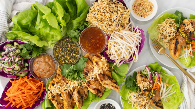 Thai lettuce wraps with chicken, vegetables, noodles, and sauces