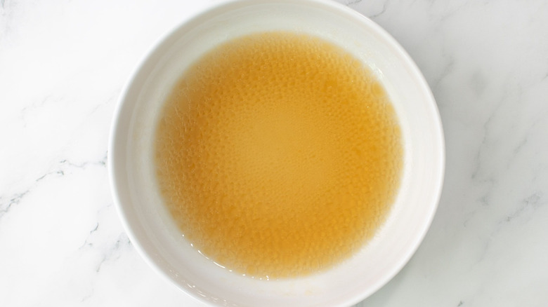 Light brown liquid in white bowl