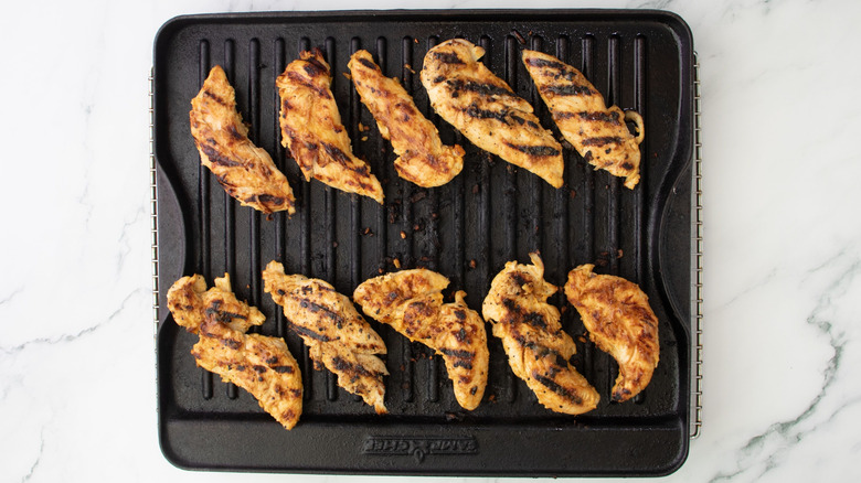 Chicken tenderloins cooking on grill pan