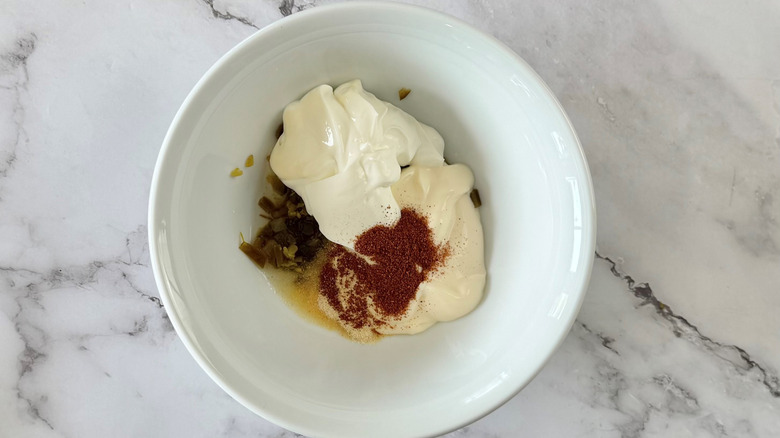 condiments and seasonings in a white bowl on a marble surface