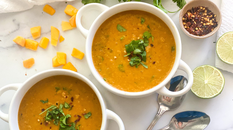 butternut squash soup in bowls with lime and pepper 