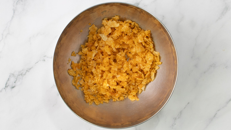 crushed potato chips in a metal bowl
