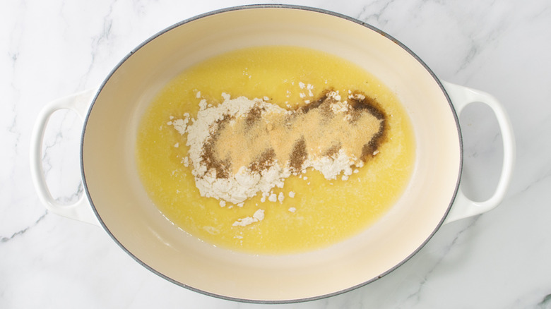 flour and seasonings on top of melted butter