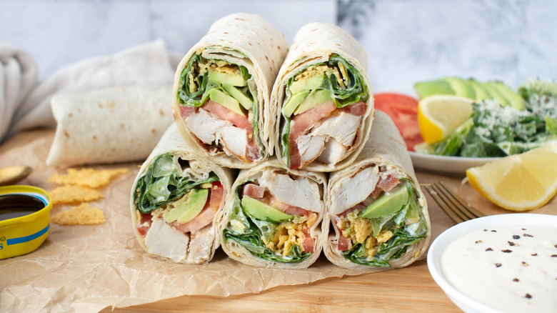 half wrap sandwiches piled in a pyramid on a countertop