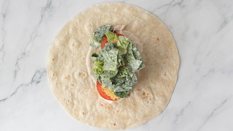 flour tortilla covered in salad