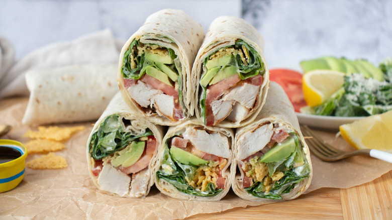 half wrap sandwiches piled in a pyramid on a countertop