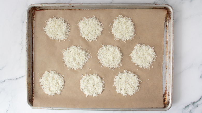 unbaked parmesan patties in a baking pan