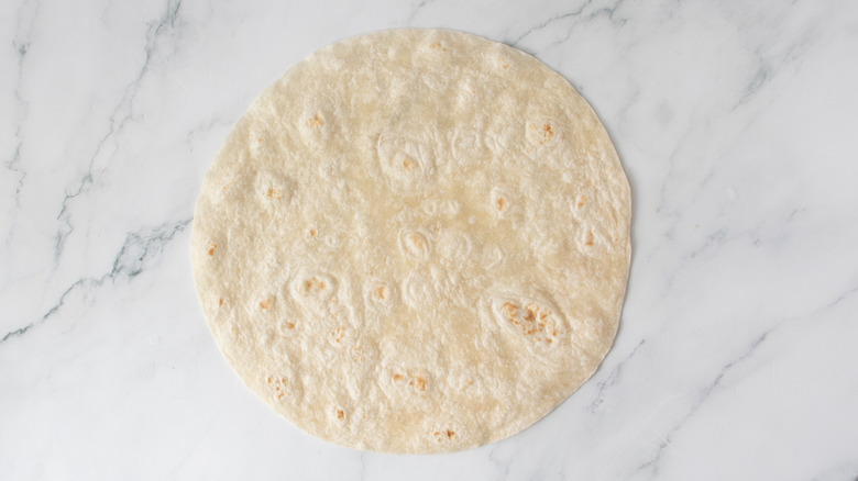 one flour tortilla on a countertop