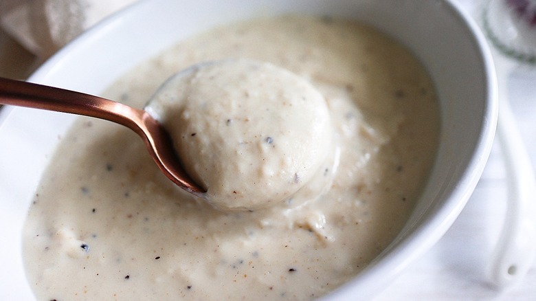 crock of gravy with spoon