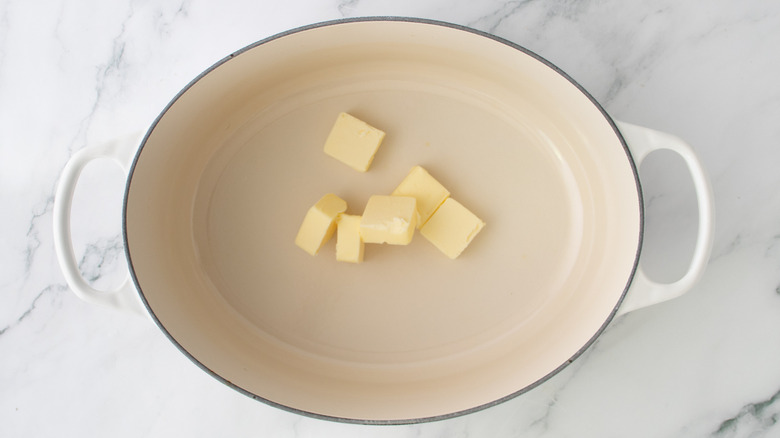 butter chunks in a white pan