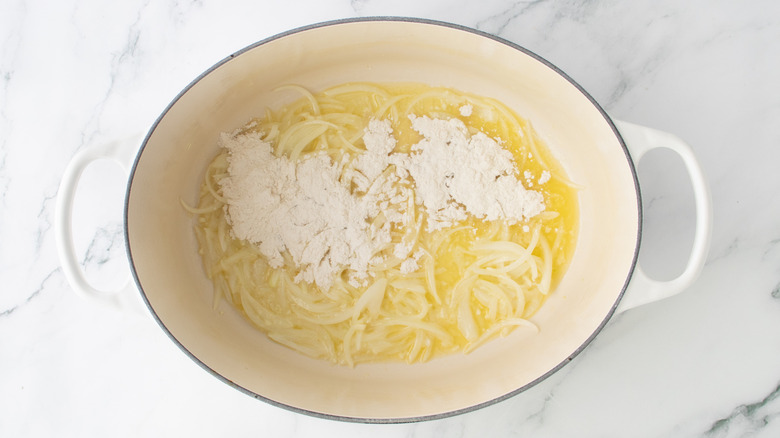 sliced onions, flour, and melted butter in a white pan