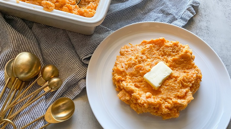 creamy mashed sweet potatoes with pat of butter