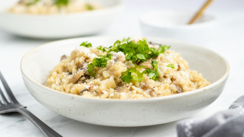 creamy mushroom risotto in bowl 