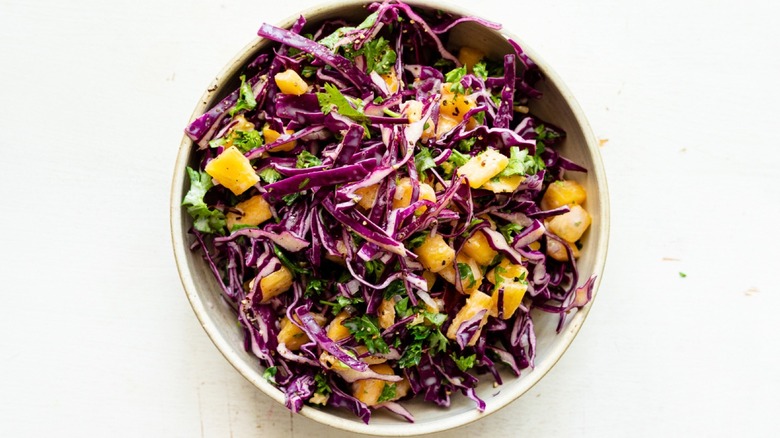 creamy pineapple coleslaw in bowl with spoon