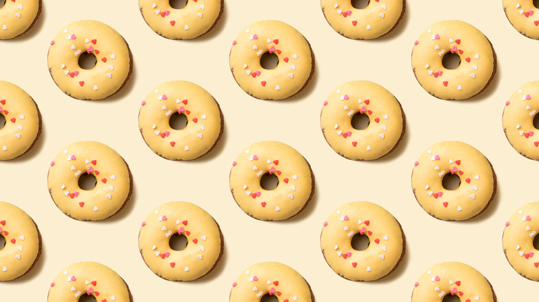 yellow iced donuts with sprinkles