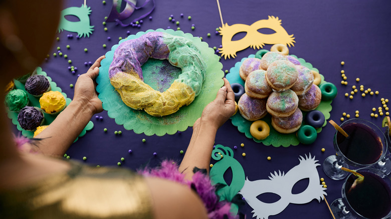 A woman serving a King Cake