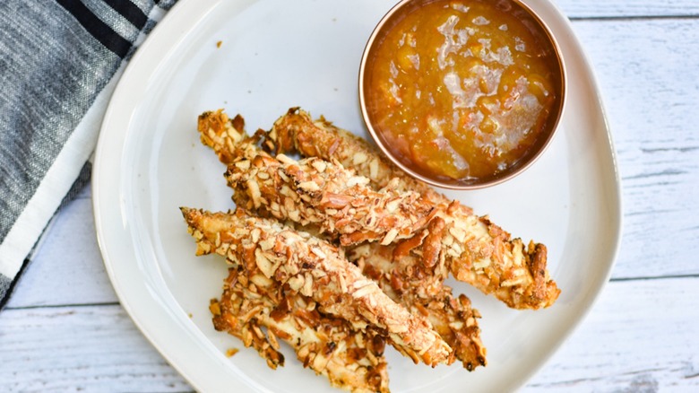 pretzel chicken fries on plate with orange dipping sauce