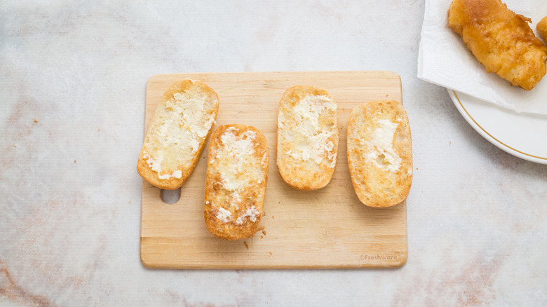 buttered rolls on wooden board