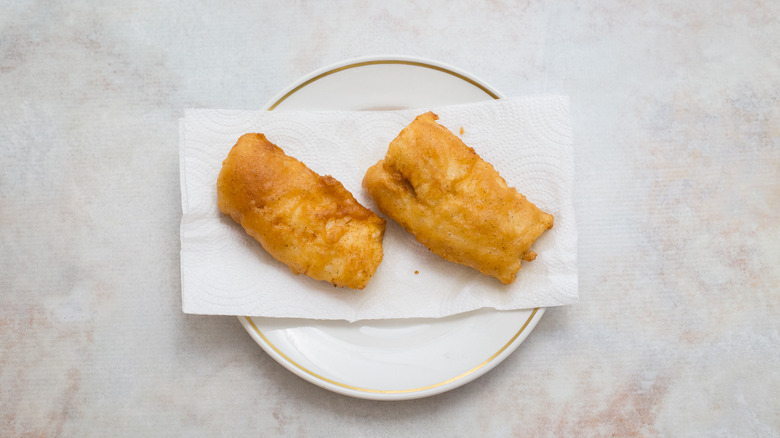 fried fish on paper towels