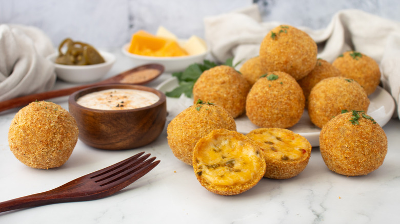 fried cheese balls on a white plate and counter